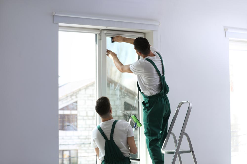 Man Adding Tint To Window