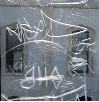 graffiti on the window that is protected by the window film - business window - Brisbane